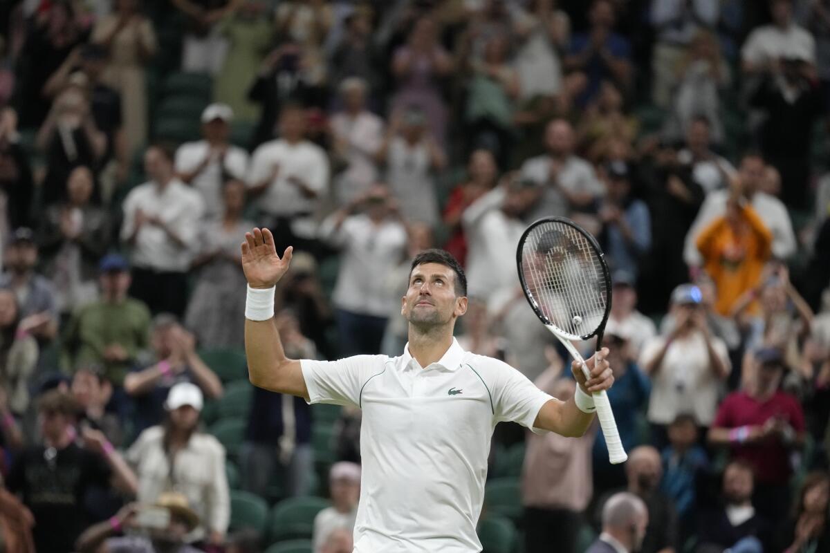 Serbia's Novak Djokovic celebrates defeating Tim van Rijthoven of the Netherlands during a men's fourth round singles match on day seven of the Wimbledon tennis championships in London, Sunday, July 3, 2022.(AP Photo/Kirsty Wigglesworth)
