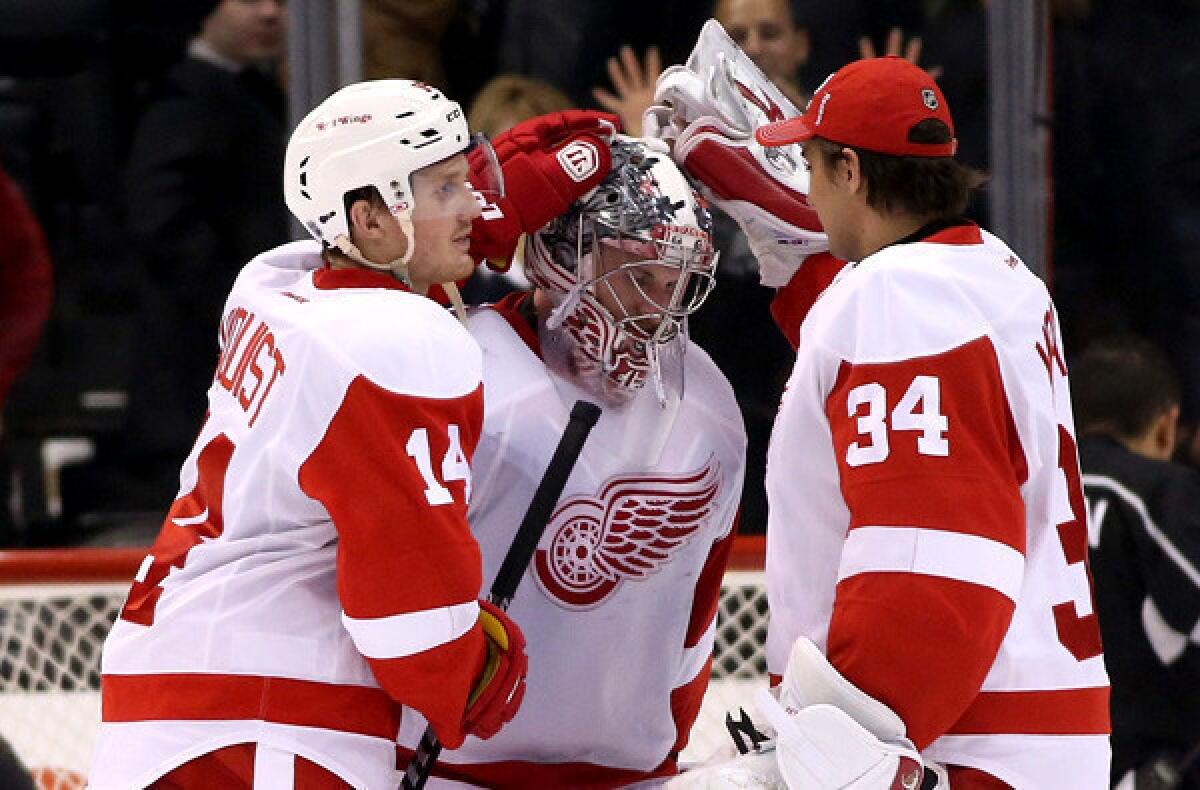 Red Wings goalie Jimmy Howard is congratulated by teammates Gustav Nyquist (14) and Petr Mrazek (34) after a 3-1 victory over the Kings in Los Angeles last week.