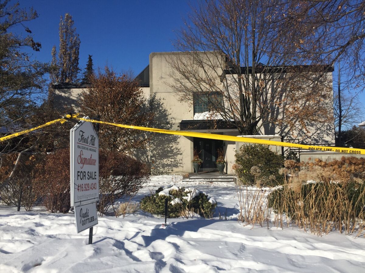 FILE - This Jan. 6, 2018 file photo shows police crime scene tape marking off the property belonging to Barry and Honey Sherman, who were found strangled inside their home on Dec. 15, 2017. Police are asking for the public's help, Tuesday, Dec. 14, 2021, after releasing video of a suspect in the killing of Canadian drug company billionaire Barry Sherman and his wife four years ago.(AP Photo/Rob Gillies, File)