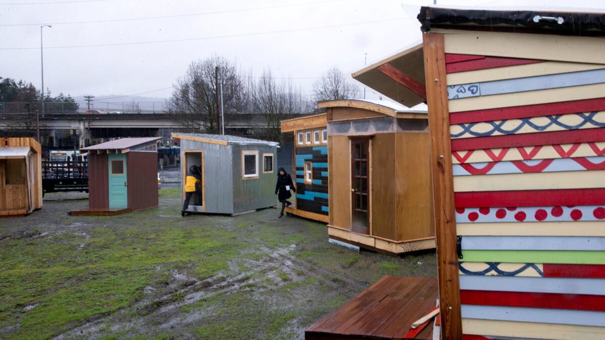 The tiny houses built for a new homeless village in Portland, Ore., do not have running water or electricity, but they do have solar panels that can power a cellphone.