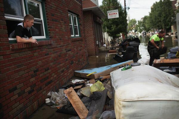 A man looks out over a flooded street on August 31, 2011 in Wallington, New Jersey. New Jersey.