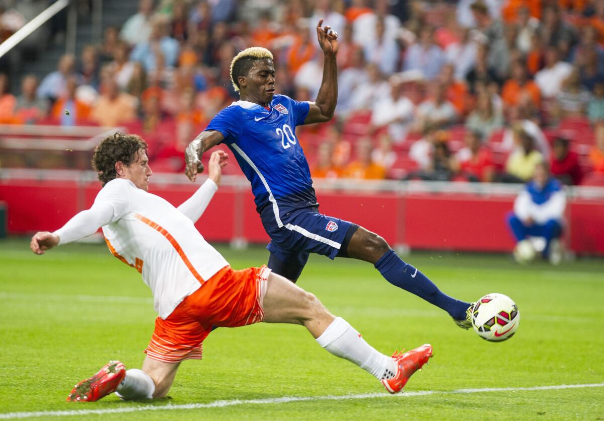 Gyasi Zardes of the United States scores a goal in front of Daryl Janmaat of Netherlands during an international friendly in Amsterdam. The U.S. beat Netherlands, 4-3.