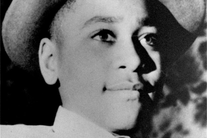 A portrait of Emmett Louis Till, wearing a hat and a shirt and tie.
