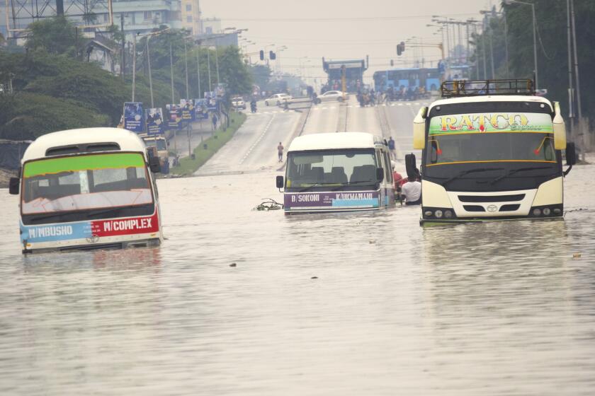 Public minibus are submerged in the flooded streets of Dar salaam, Tanzania Thursday, April 25, 2024. Flooding in Tanzania caused by weeks of heavy rain has killed 155 people and affected more than 200,000 others, the prime minister said Thursday. (AP Photo)