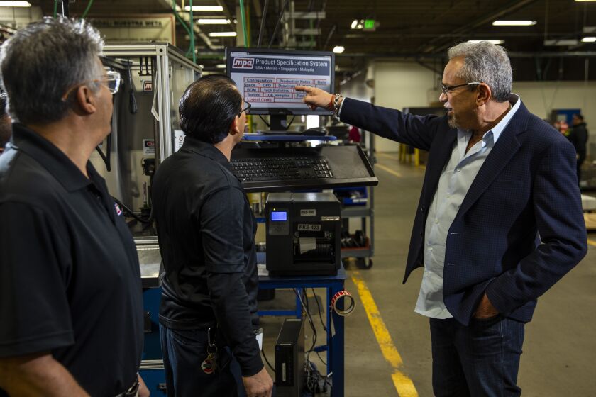 TORRANCE, CA --DECEMBER 16, 2019—Selwyn Joffee, chairman, president and CEO of Motorcar Parts of America, right, talks with workers at the company’s world headquarters, in a Torrance, CA, Dec 16, 2019. (Jay L. Clendenin / Los Angeles Times