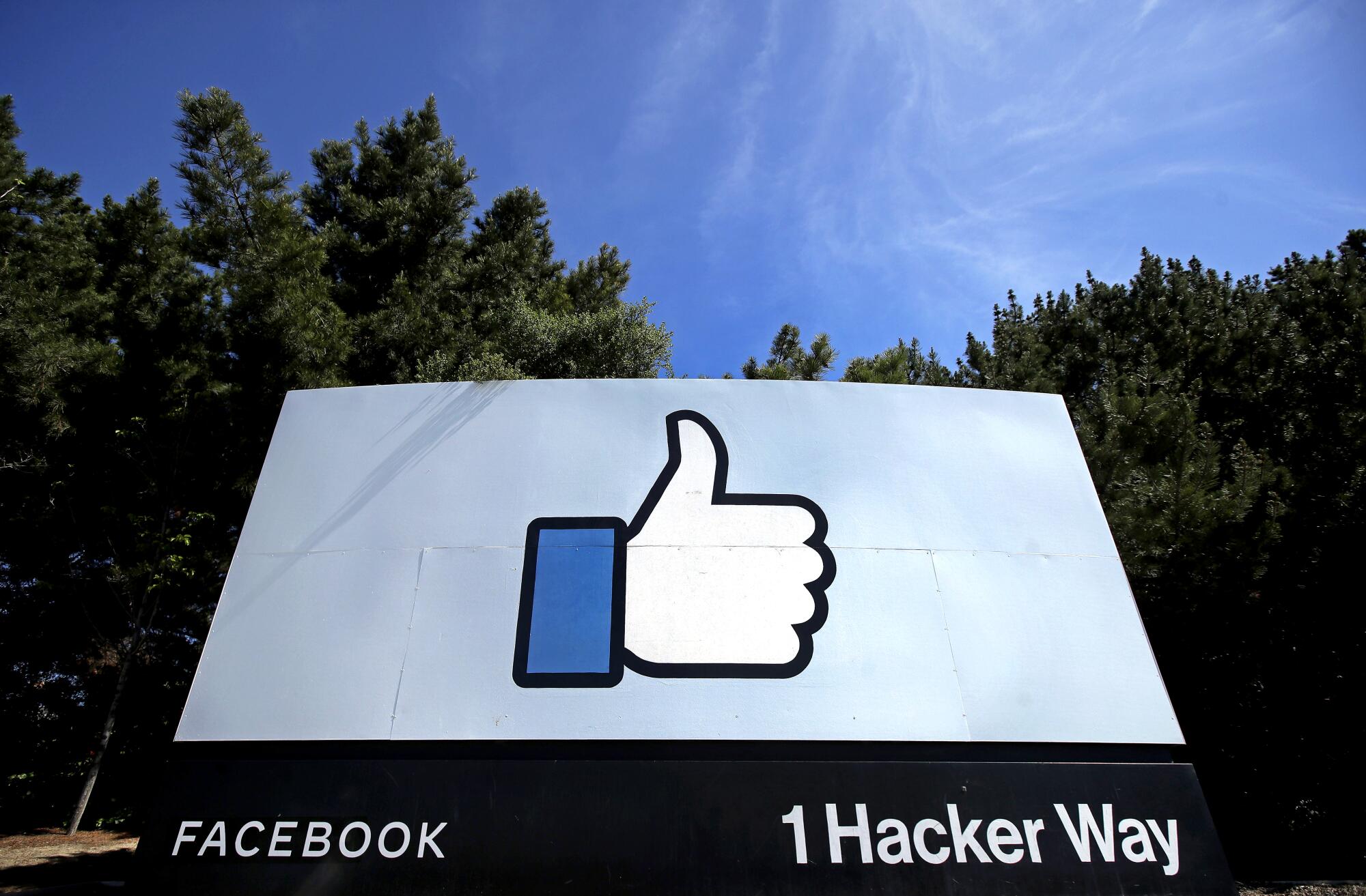 The thumbs-up "like" logo is shown on a sign at Facebook headquarters in Menlo Park, Calif.