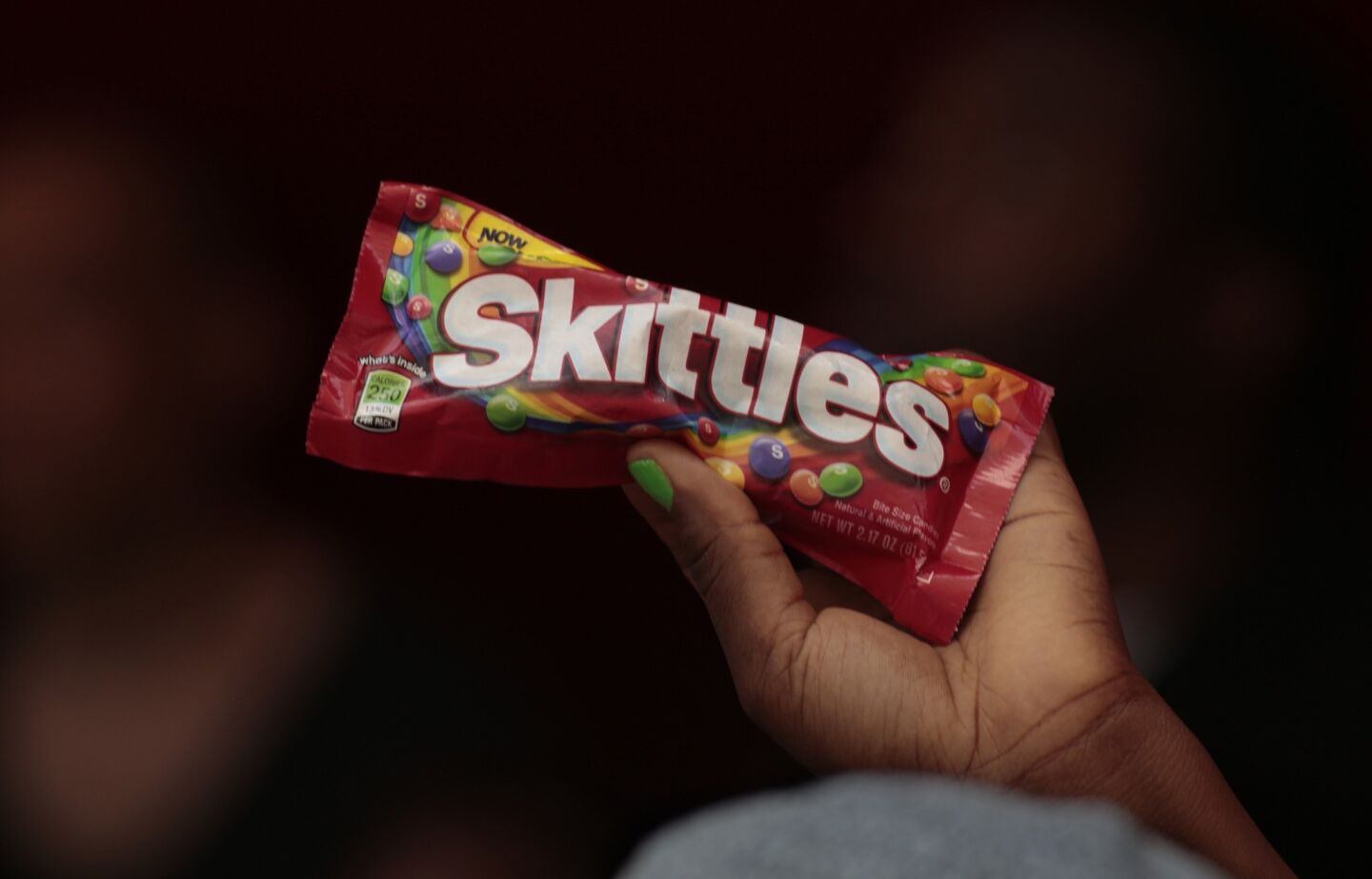 A protestor holds up a bag of Skittles. At the time of Trayvon Martin's death, he was carrying a bag of Skittles and a can of tea.