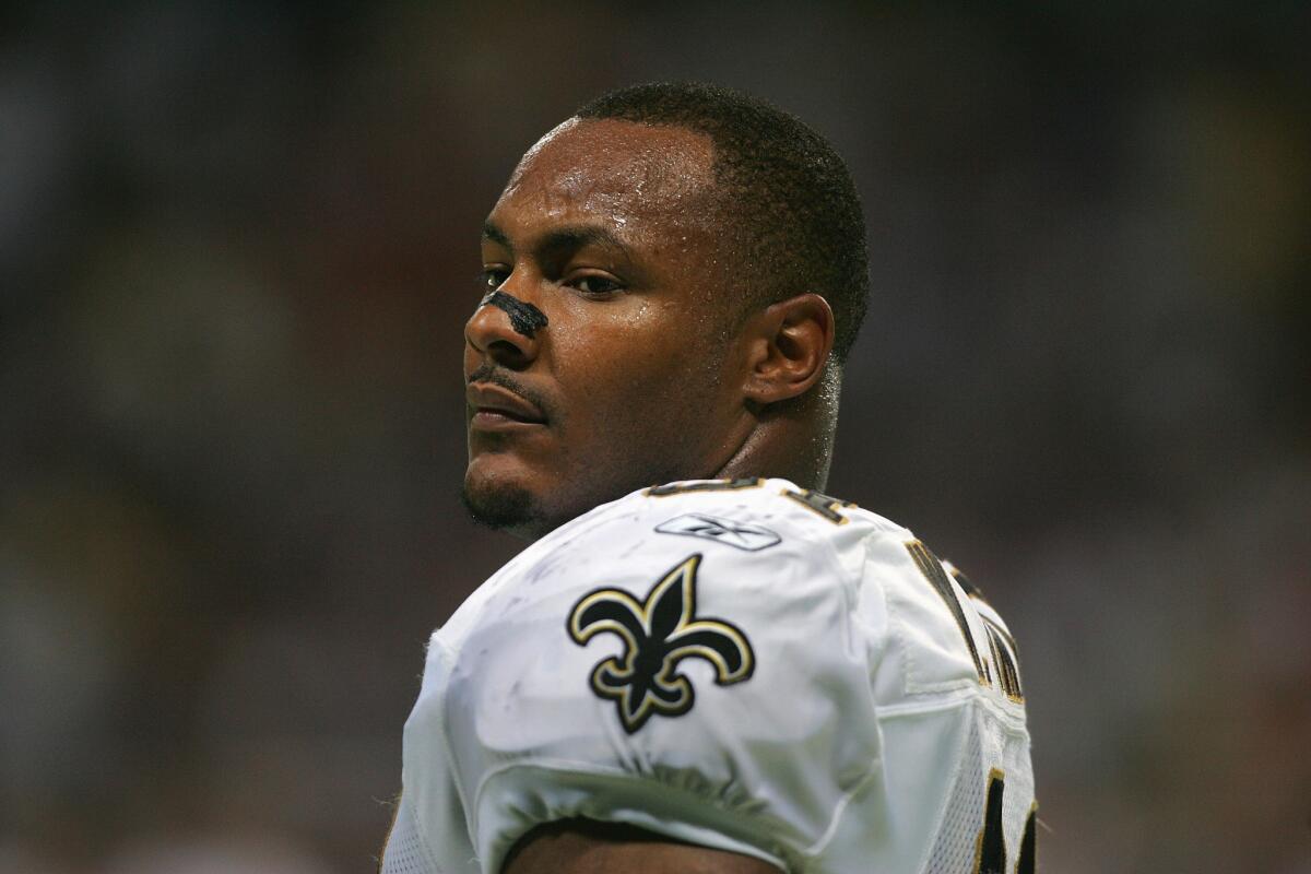 Former Saints defensive end Will Smith is shown on the field during a game against the St. Louis Rams on Sept. 26, 2004.