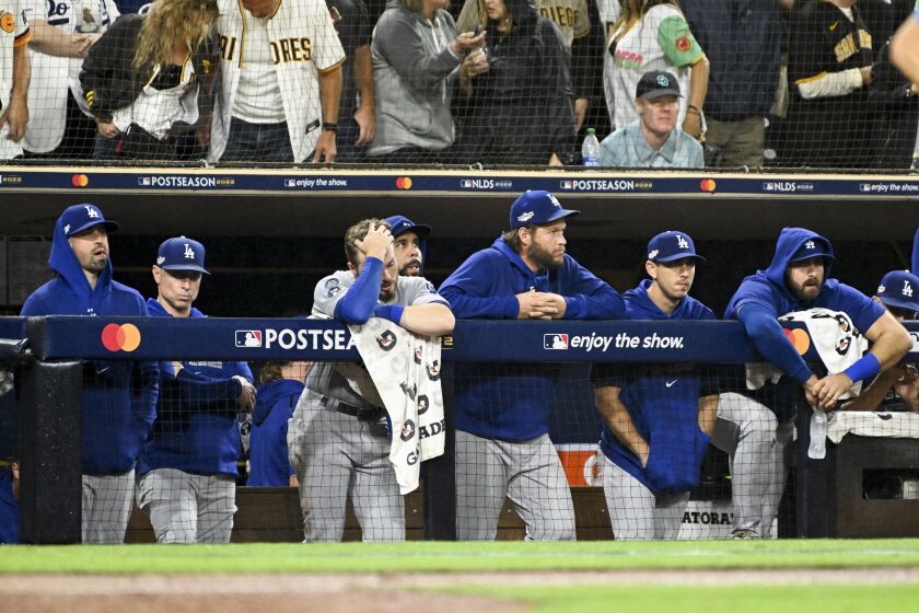 San Diego, CA - October 15: The Los Angeles Dodgers dugout watches during the ninth inning in game 4 of the NLDS against the San Diego Padres at Petco Park on Saturday, Oct. 15, 2022 in San Diego, CA. (Wally Skalij / Los Angeles Times)