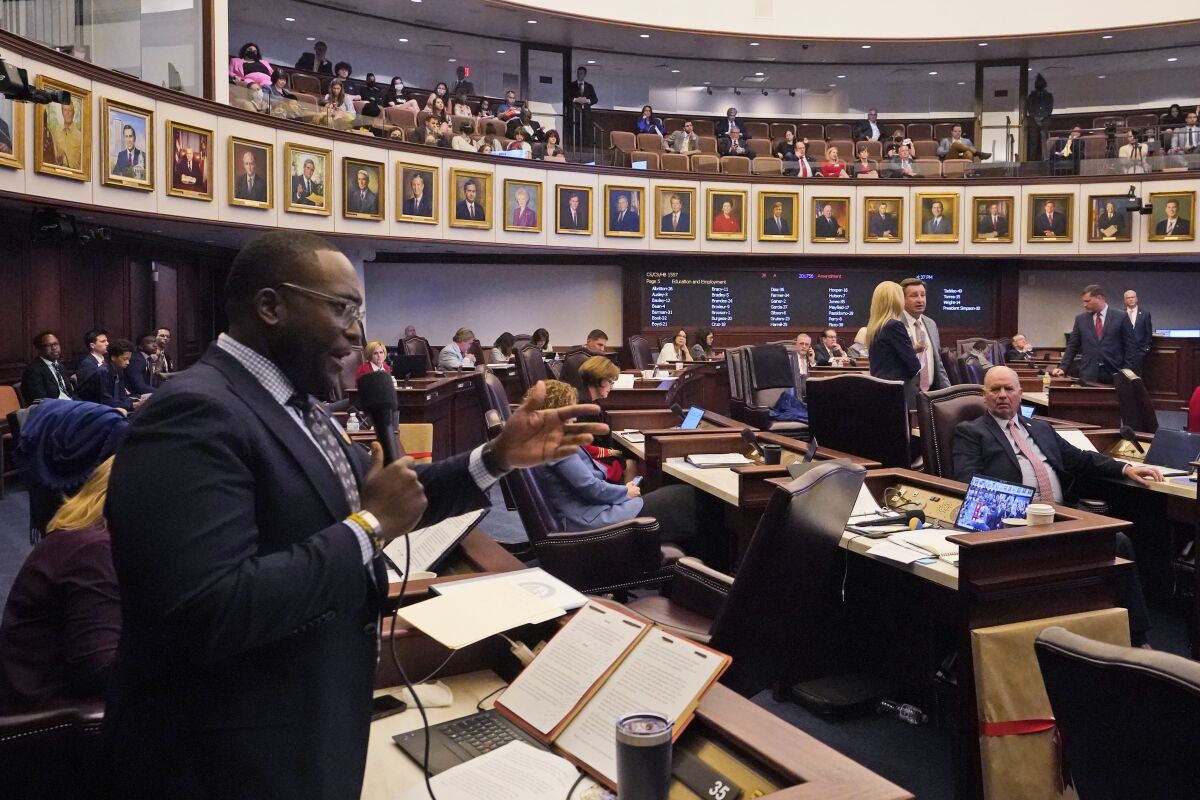 Florida Sen. Shevrin Jones, left, speaks about his proposed amendment to a bill, dubbed by opponents as the "Don't Say Gay" bill, to forbid discussions of sexual orientation and gender identity in schools, during a legislative session at the Florida State Capitol, Monday, March 7, 2022, in Tallahassee, Fla. (AP Photo/Wilfredo Lee)