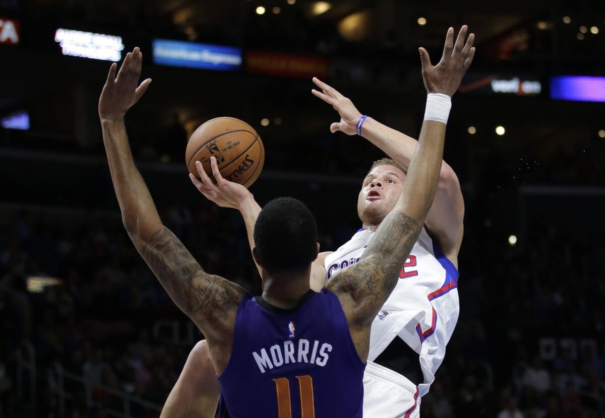 Blake Griffin shoots over Phoenix forward Markieff Morris during the first half of the Clippers' 121-120 overtime win Monday over the Phoenix Suns at Staples Center.