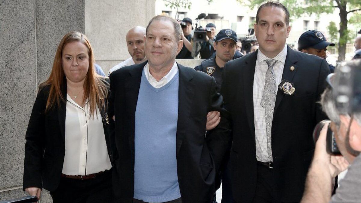 Harvey Weinstein arrives for arraignment at Manhattan Criminal Courthouse in handcuffs after being arrested and processed on charges of first-degree rape, third-degree rape and first-degree criminal sexual act on Friday.