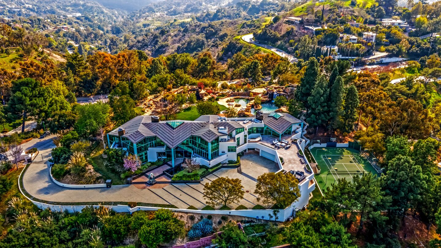 Set on four acres in the Beverly Hills Post Office area, the architectural estate is a world of its own, with koi ponds and waterfalls that dot the hilltop grounds that surround it.