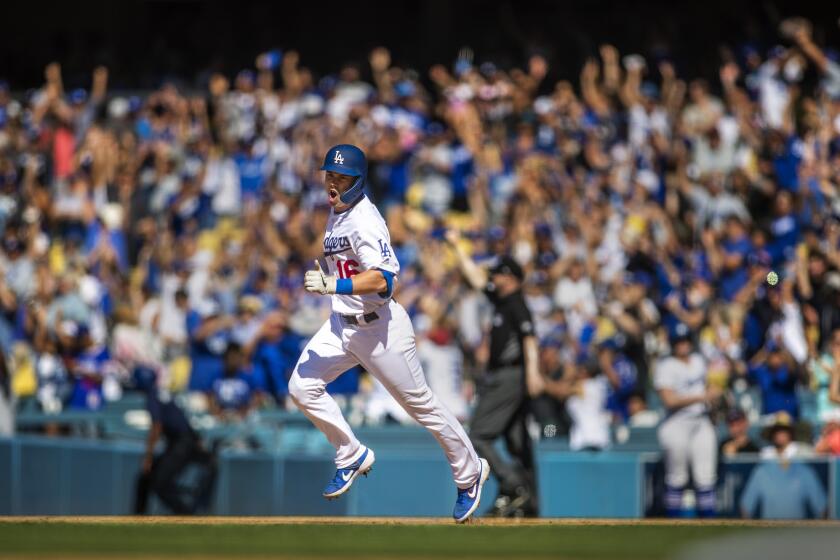 LOS ANGELES, CALIF. -- SUNDAY, JUNE 23, 2019: As the crowd cheers, Dodgers rookie Will Smith celebrates his three-run walk-off home run while rounding the bases in the bottom of the ninth inning to sweep the Rockies with three walk-offs at Dodger Stadium in Los Angeles, Calif., on June 23, 2019. Dodgers won 6-3. (Allen J. Schaben / Los Angeles Times)