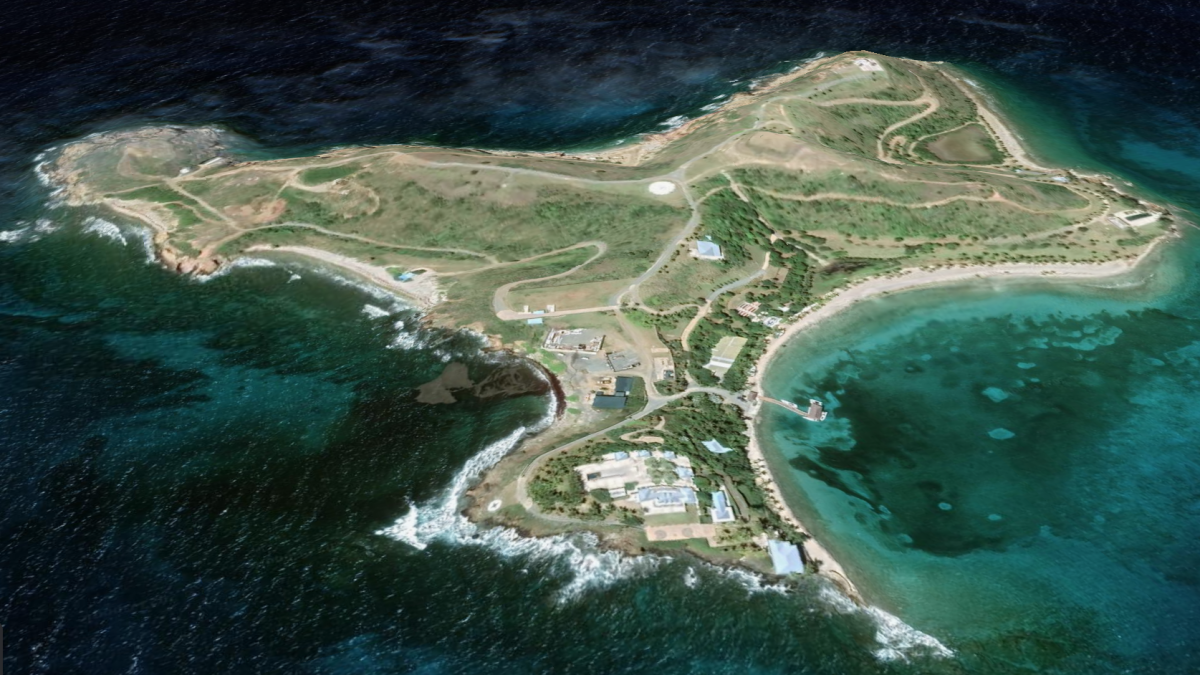 Aerial view of Little Saint James, Jeffrey Epstein’s private island in the U.S. Virgin Islands, showing coastal buildings, docks, and turquoise waters surrounding the landmass.
