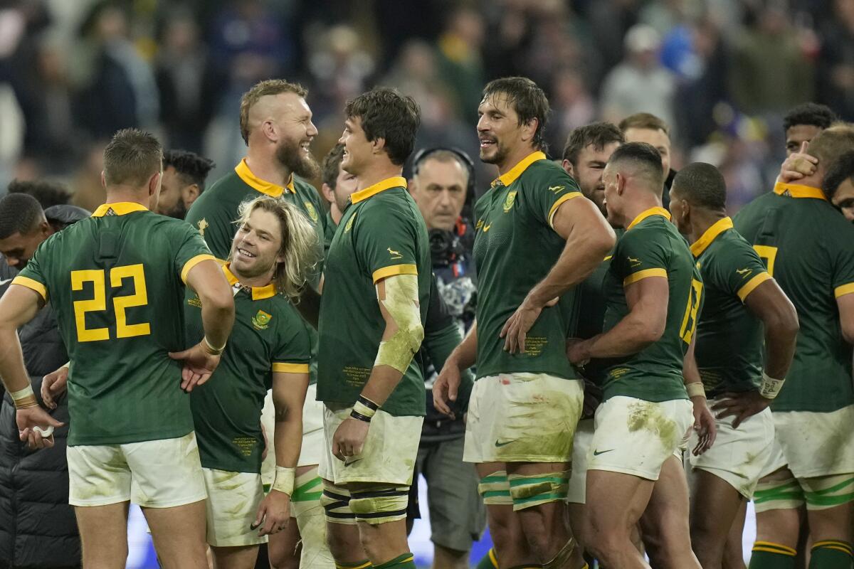 South African players celebrate after they won the Rugby World Cup quarterfinal match between France and South Africa at the Stade de France in Saint-Denis, near Paris Sunday, Oct. 15, 2023. (AP Photo/Christophe Ena)