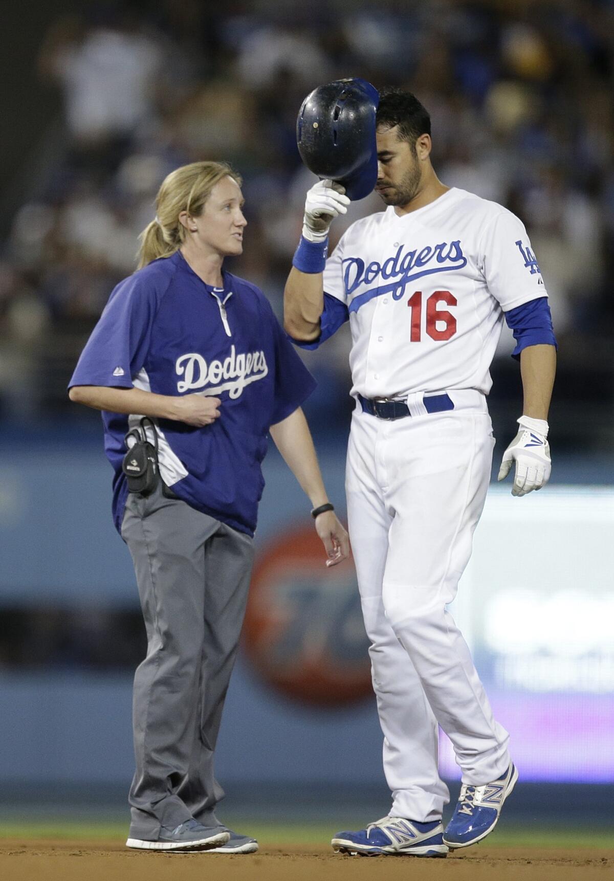 Dodgers center fielder Andre Ethier speaks with assistant athletic trainer Nancy Patterson after suffering a left ankle injury during the eighth inning of the Dodgers' 4-2 loss to the San Francisco Giants.