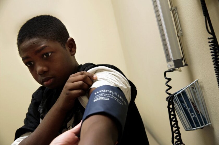 Go ahead, blame Obamacare: A Louisiana teen gets his blood pressure checked.