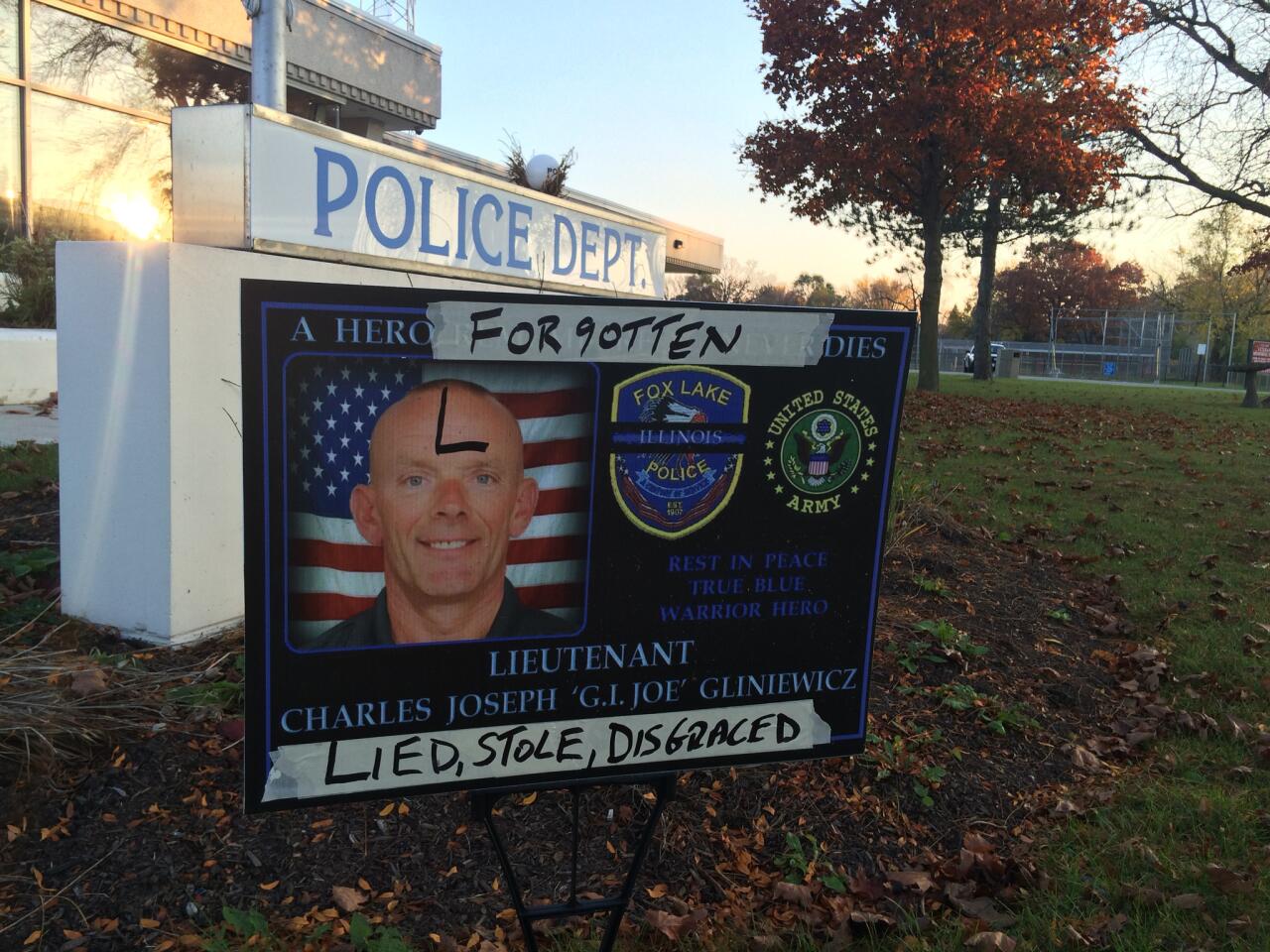 A sign honoring Lt. Charles Joseph "G.I. Joe" Gliniewicz is defaced outside Fox Lake Police Department on Nov. 4, 2015.