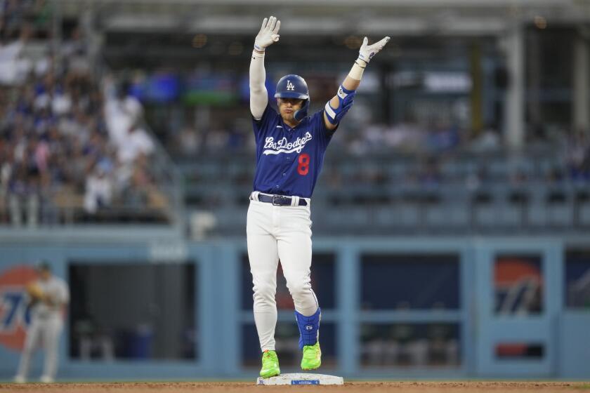 Los Angeles Dodgers' Kiké Hernández (8) celebrates after a double during the second inning of a baseball game against the Oakland Athletics in Los Angeles, Thursday, Aug. 3, 2023. (AP Photo/Ashley Landis)