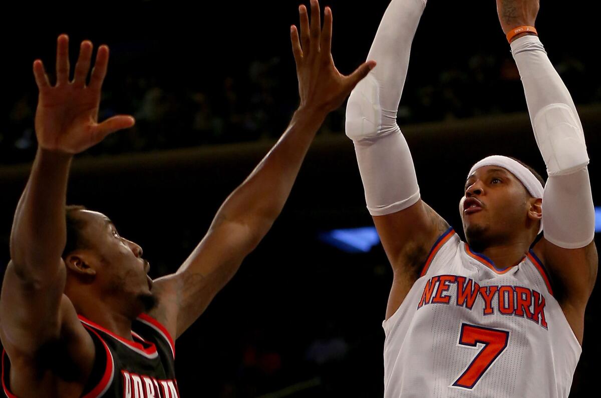 Carmelo Anthony of the New York Knicks takes a shot as Al-Farouq Aminu of the Portland Trail Blazers defends Tuesday at Madison Square Garden.