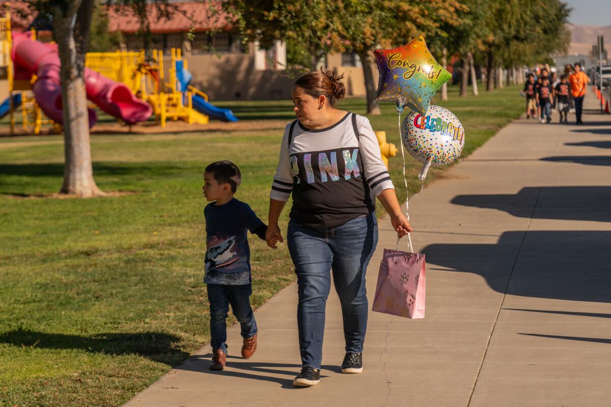 Veronica Lopez walks her son, Enzo Cisneros, 5, to Sunset Elementary School in Coalinga. 