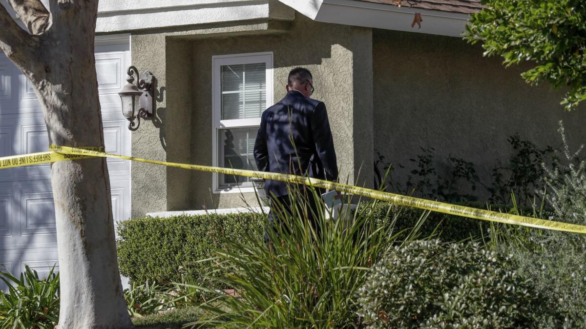 L.A. County Sheriff detectives and crime scene investigator at house on Startree Lane in Santa Clarita,where four people were found shot to death Friday.