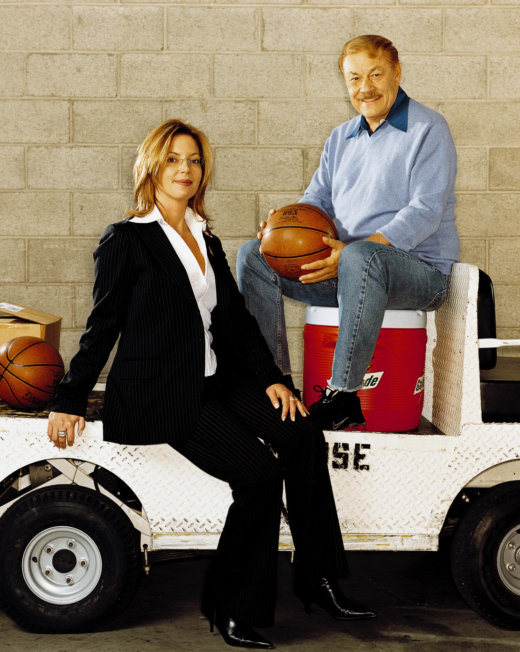 Lakers owner Jerry Buss and his daughter, Jeanie, pose for a photo at the Staples Center.