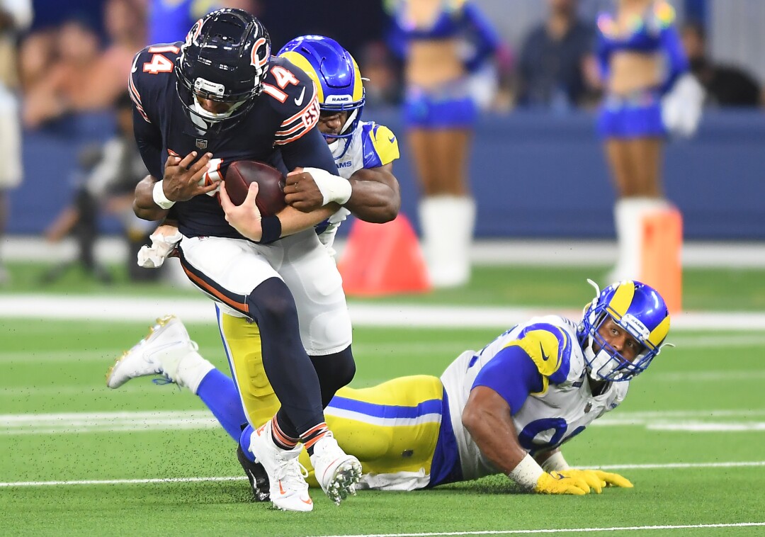 Los Angeles Rams Justin Hollins sacks Chicago Bears quarterback Andy Dalton as Aaron Donald looks on