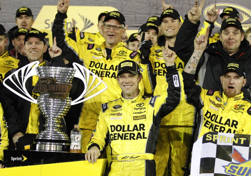 FILE - Matt Kenseth, center, stands next to the trophy in Victory Lane after winning the NASCAR Sprint Unlimited auto race at Daytona International Speedway, on Feb. 14, 2015, in Daytona Beach, Fla. was Kenseth was elected to NASCAR's Hall of Fame on Wednesday, May 4 2022. (AP Photo/Terry Renna, File0