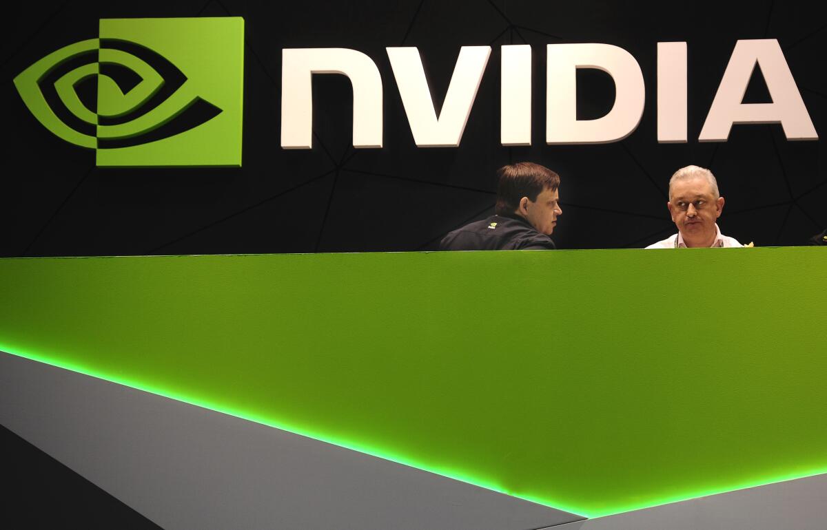 People are in the Nvidia booth at a mobile phone trade show.