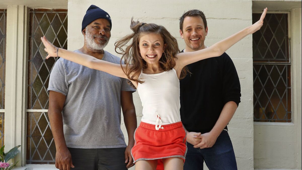 David Alan Grier (Oliver "Daddy" Warbucks), left, Kaylin Hedges (Annie) and director Michael Arden at rehearsal for the upcoming Hollywood Bowl production of "Annie."