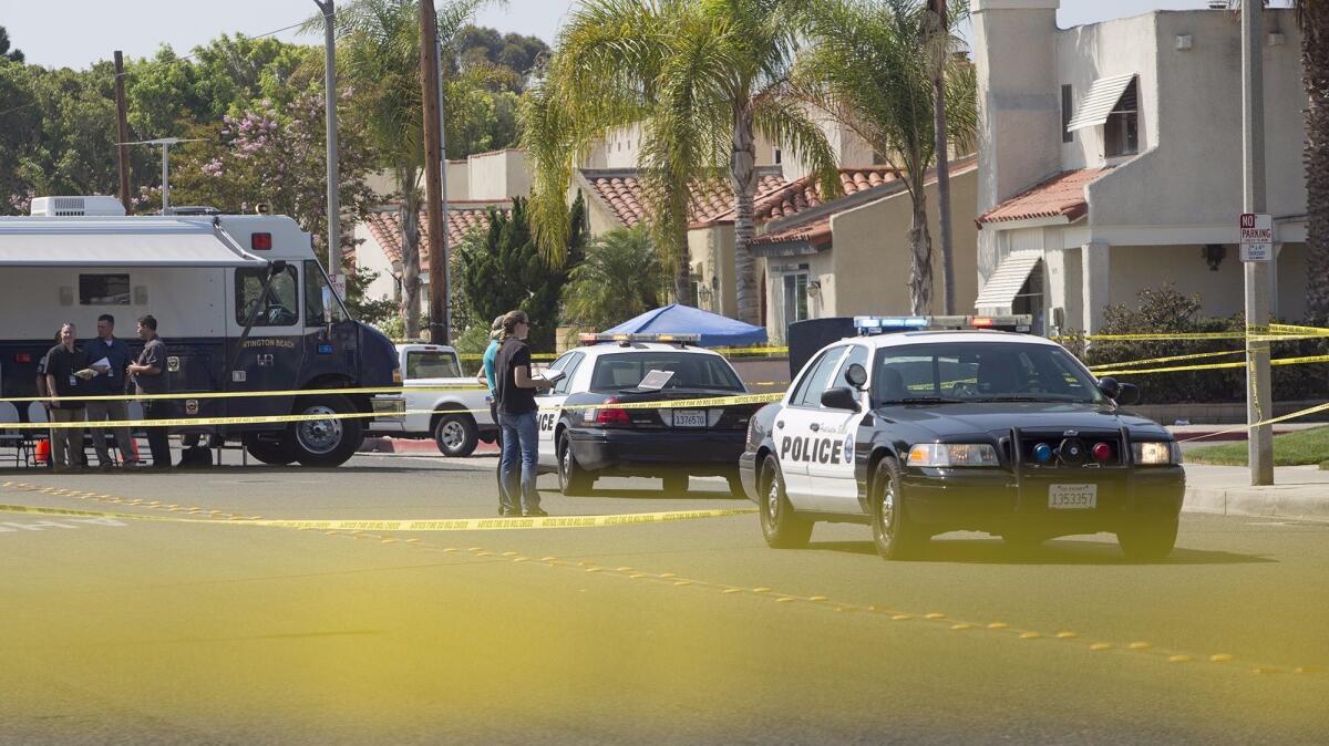Huntington Beach police investigate a shooting involving two officers at a residence along Delaware Street, near Utica Avenue, in Huntington Beach.