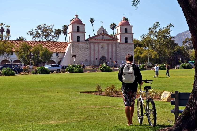 The Old Mission Santa Barbara sits next to a big lawn at the foot of a spectacular hillside neighborhood.