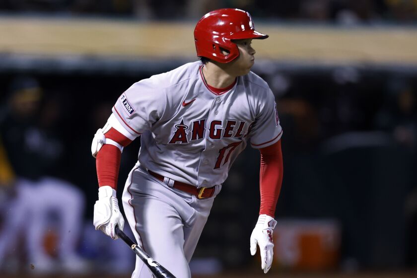 Los Angeles Angels' Shohei Ohtani runs to first after hitting a single against the Oakland Athletics.