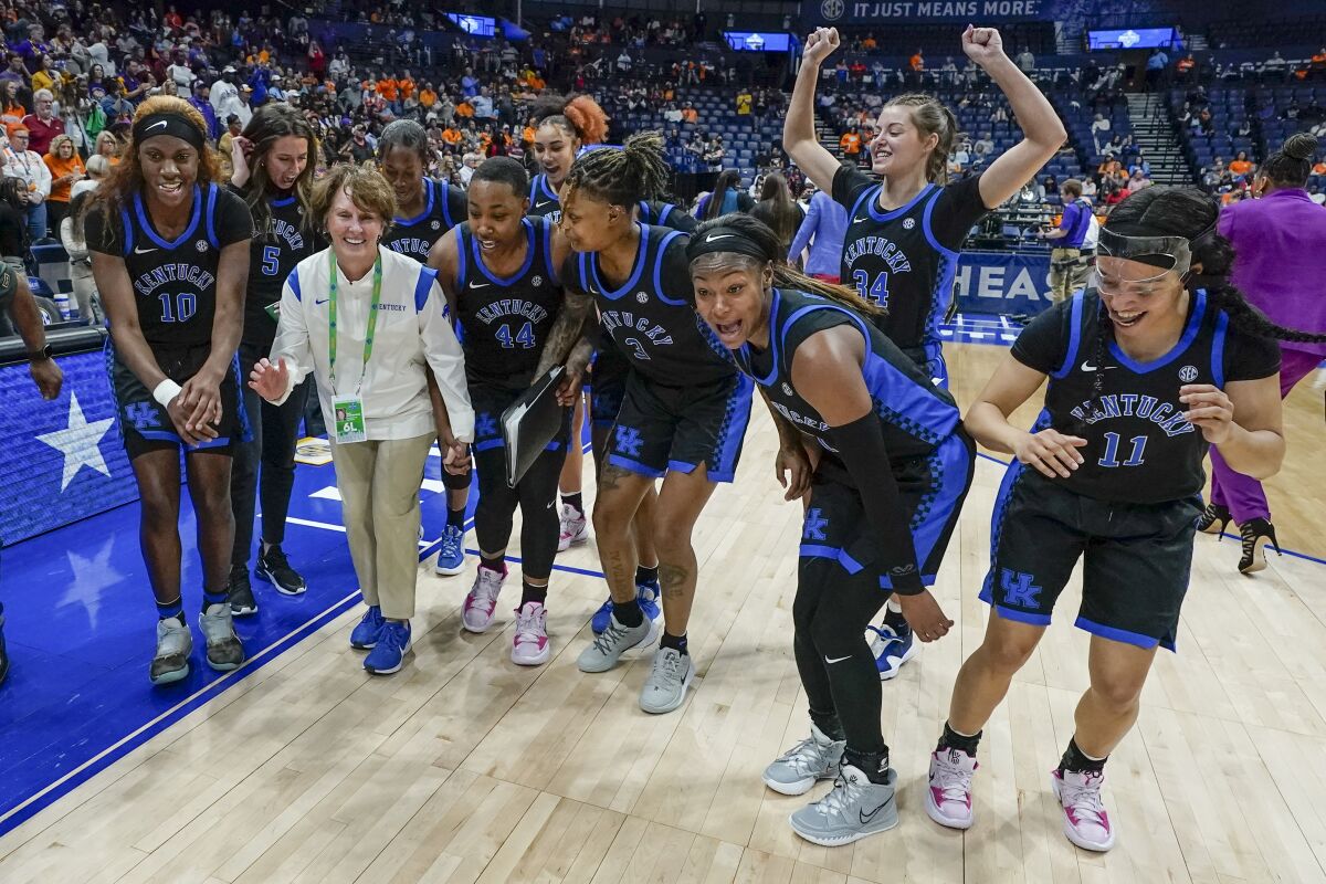 Kentucky players and staff dance and celebrate after beating LSU in an NCAA college basketball game at the women's Southeastern Conference tournament Friday, March 4, 2022, in Nashville, Tenn. (AP Photo/Mark Humphrey)