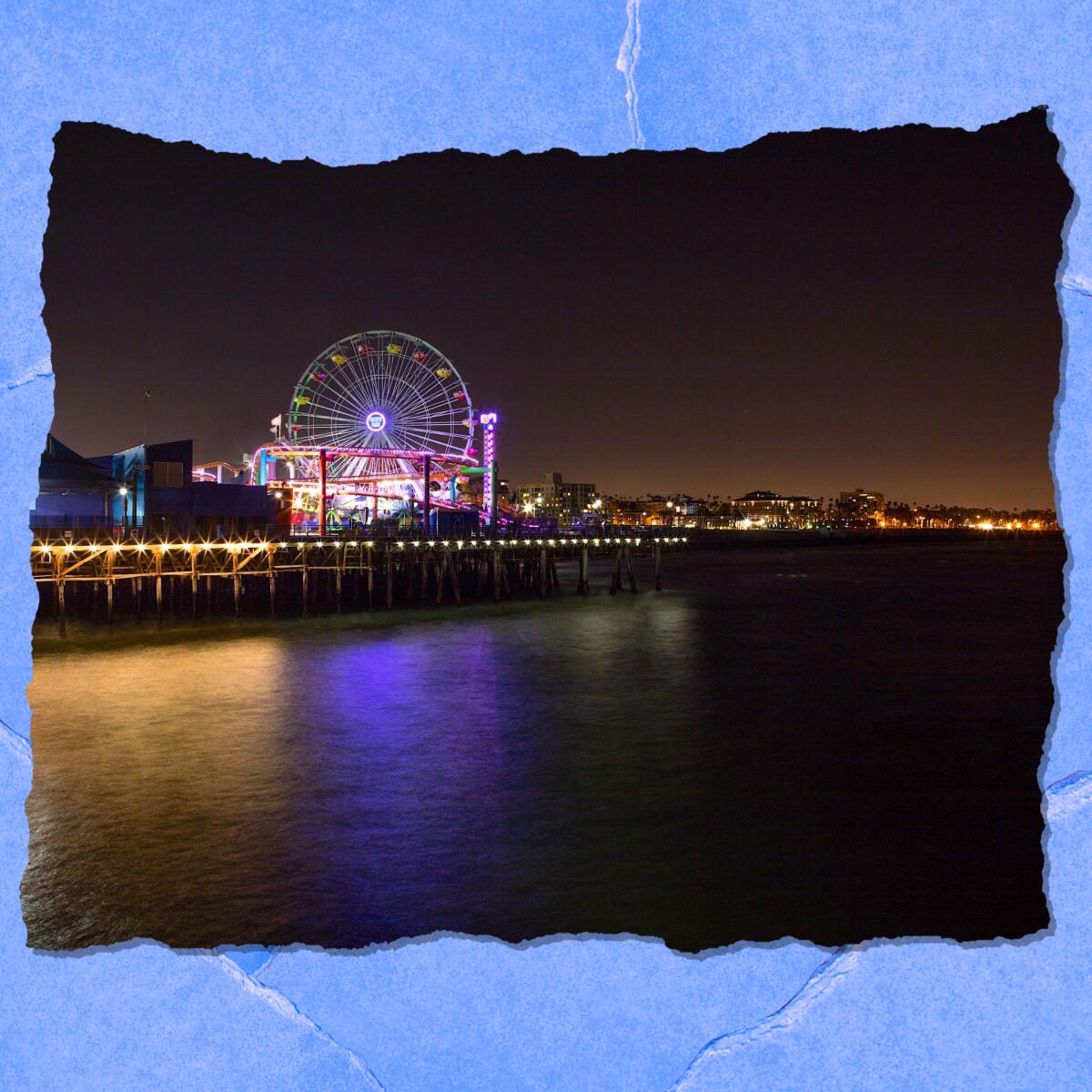 A coastline and lighted pier are shown after dark with a large lighted Ferris wheel.