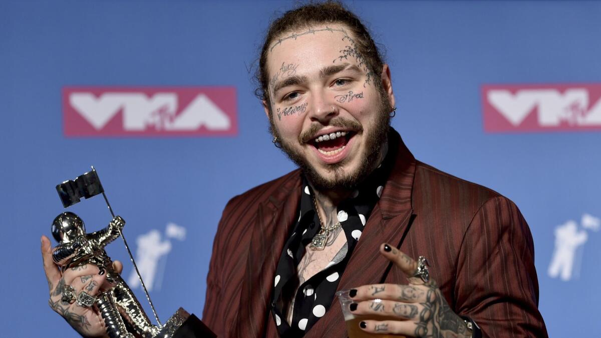 Post Malone poses with his award for song of the year for "Rockstar" backstage at the MTV Video Music Awards in August. His life was probably not in danger at any point during the evening, but who can say, really?