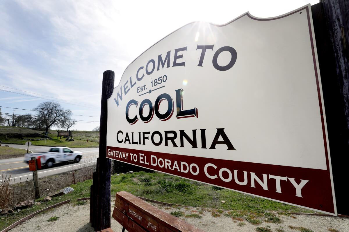 A sign next to a road welcomes people to Cool in El Dorado County.