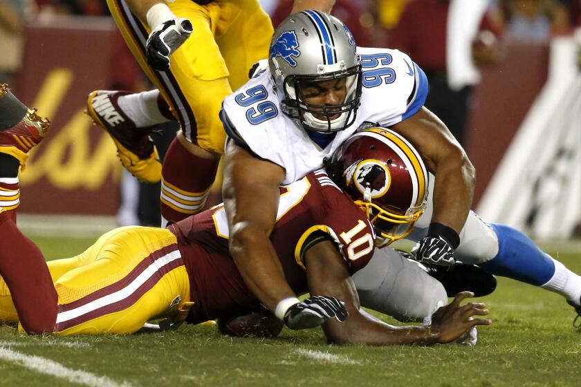 Washington quarterback Robert Griffin III is hit by Detroit defensive end Corey Wootton while trying to recover a fumble in the first half of a preseason game on Thursday night. Griffin was injured on the play.