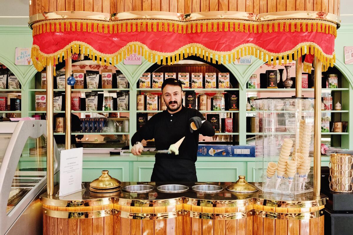 A man works in a colorful shop.