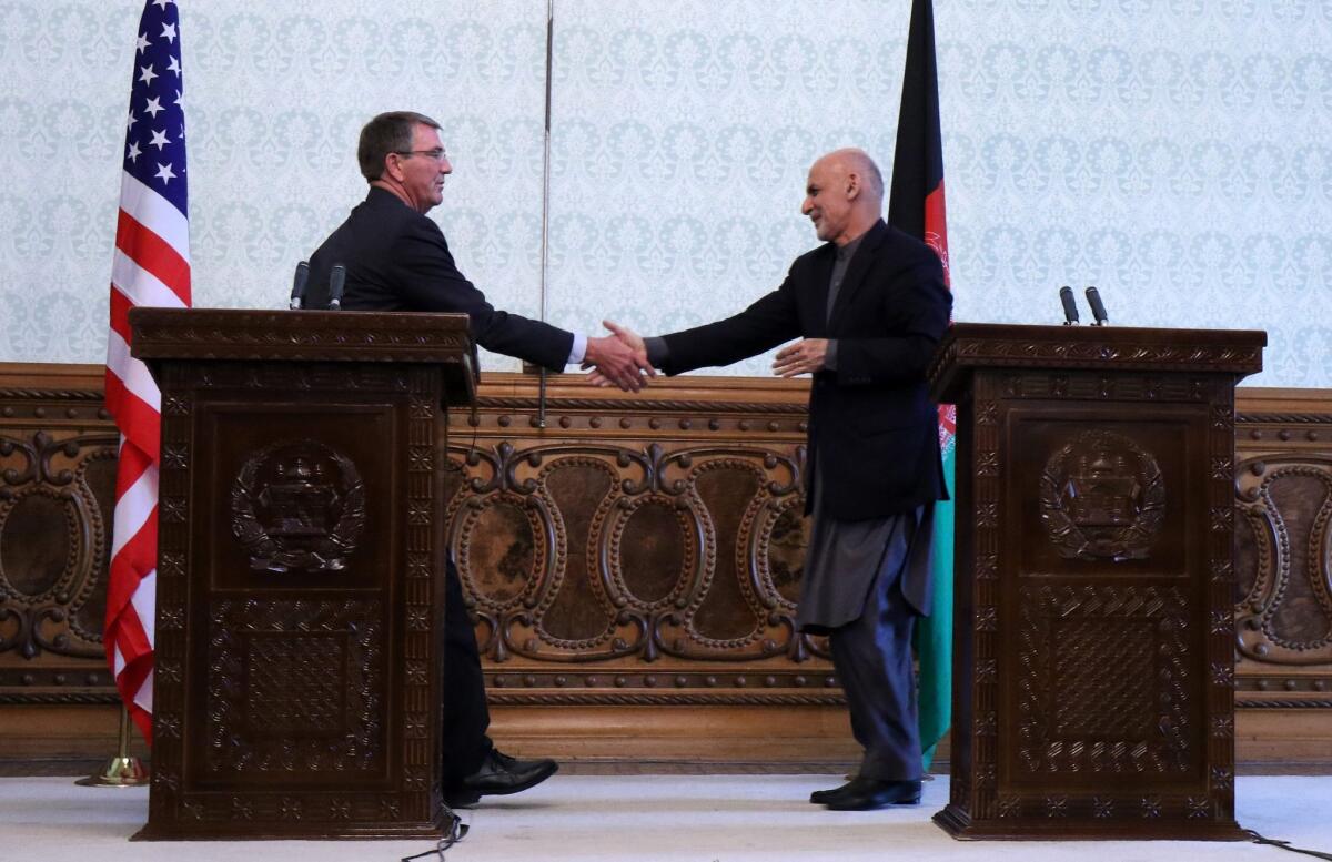 Defense Secretary Ashton Carter, left, shakes hands with Afghan President Ashraf Ghani during a news conference in Kabul on Dec. 9.