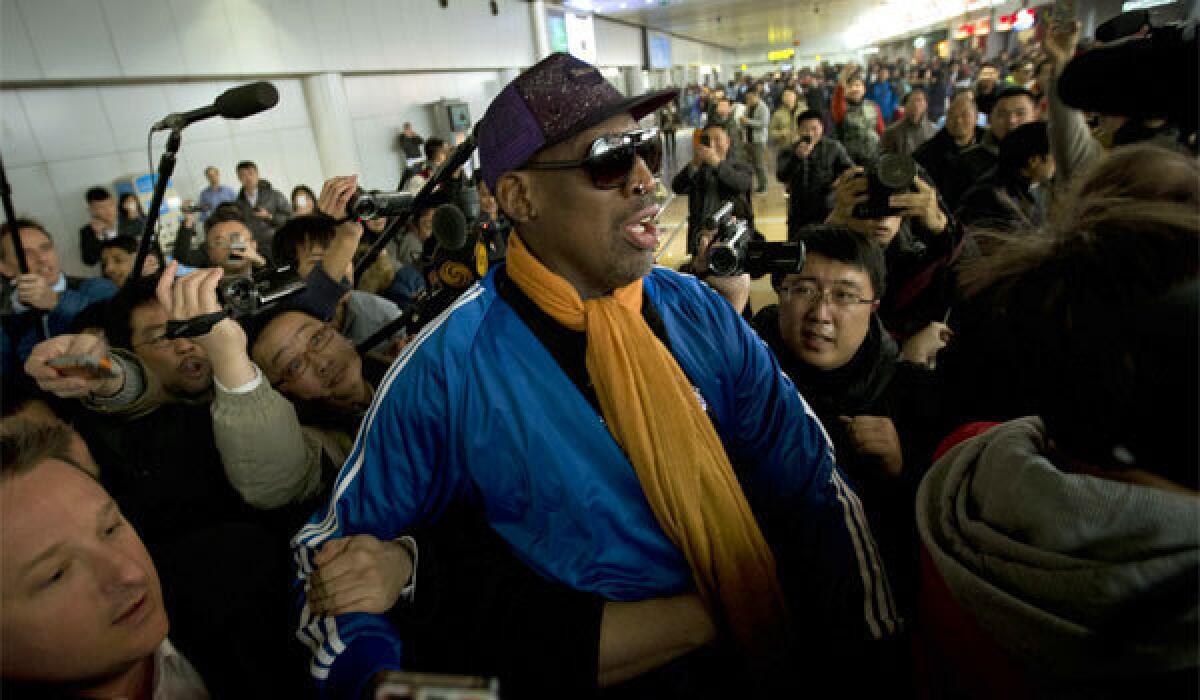 Former NBA star Dennis Rodman is followed by journalists as he arrives at the the Beijing airport after leaving North Korea on Monday.