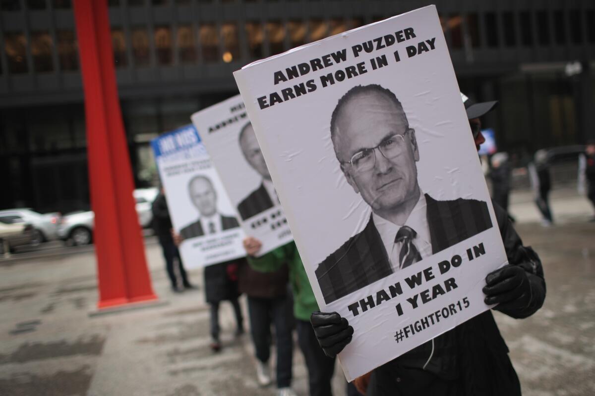 Fight for $15 workers in Chicago protest the nomination of Andy Puzder for Labor secretary.
