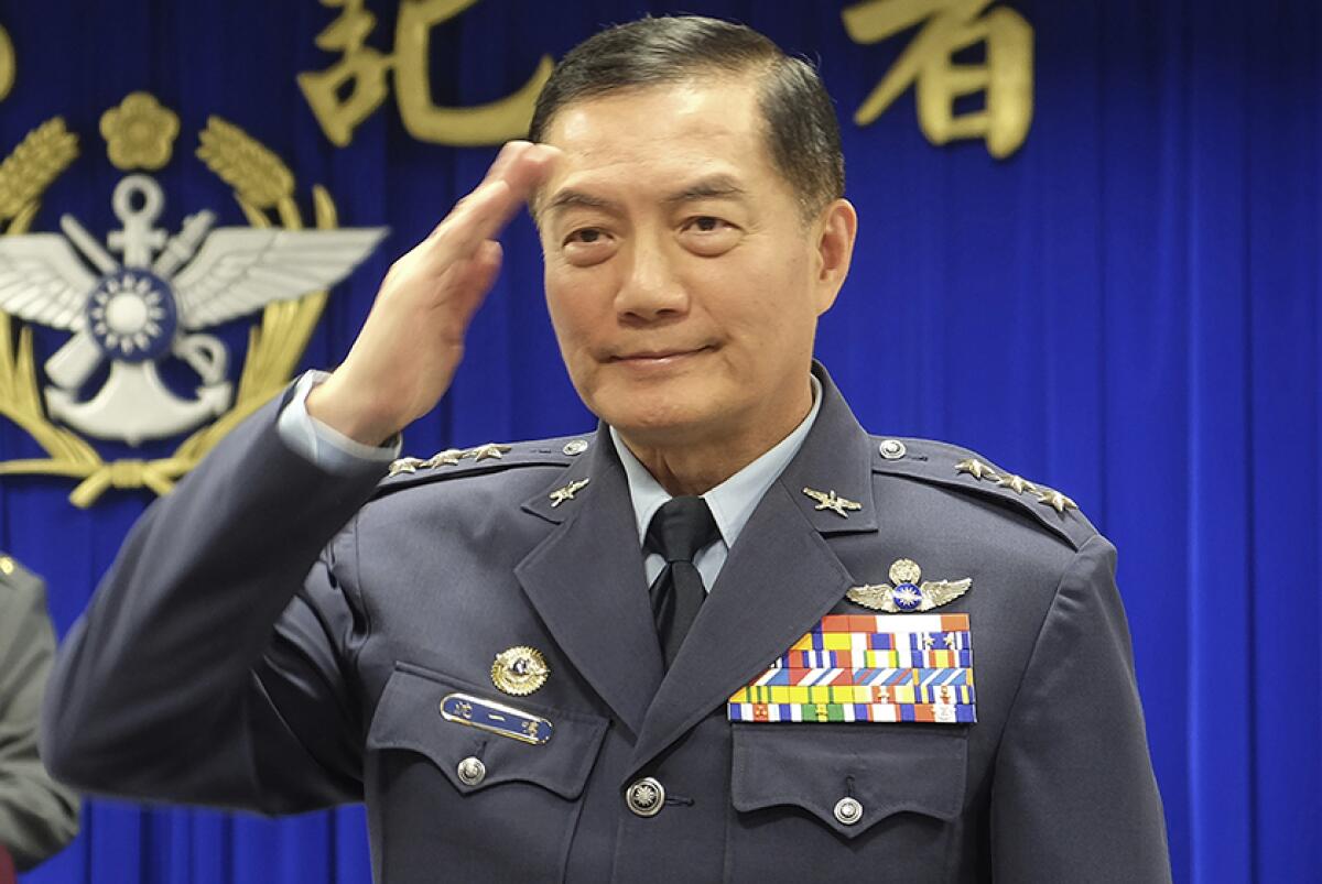 Shen Yi-ming, Taiwan's top military official, salutes as he is introduced at a news conference in Taipei on March 7.