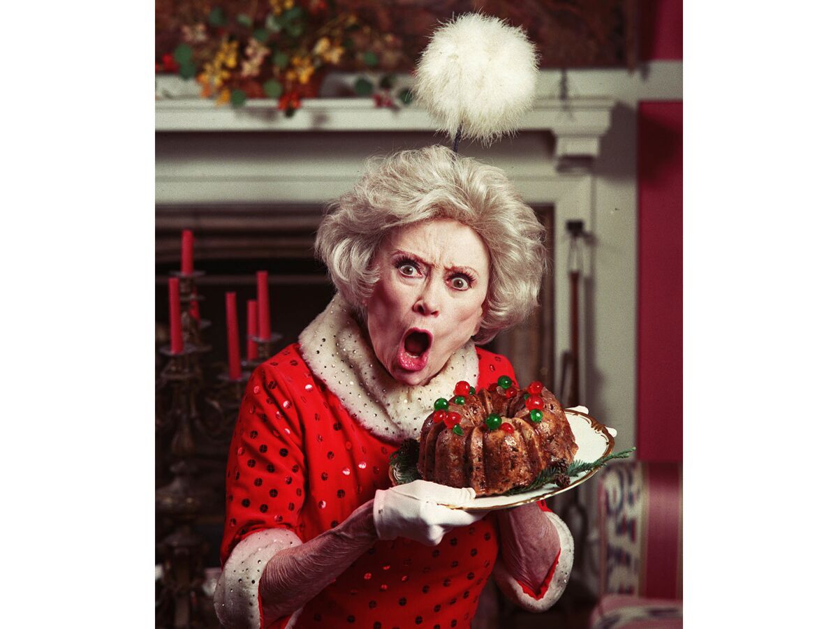 Nov. 8, 1995: Portrait of Phyllis Diller with fruitcake.
