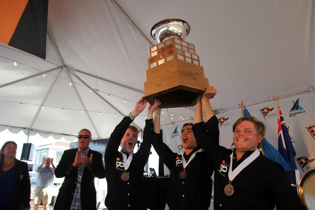 Jordan Stevenson, left, Mitch Jackson, and George Angus of the Royal New Zealand Yacht Squadron, hold up the Governor's Cup.