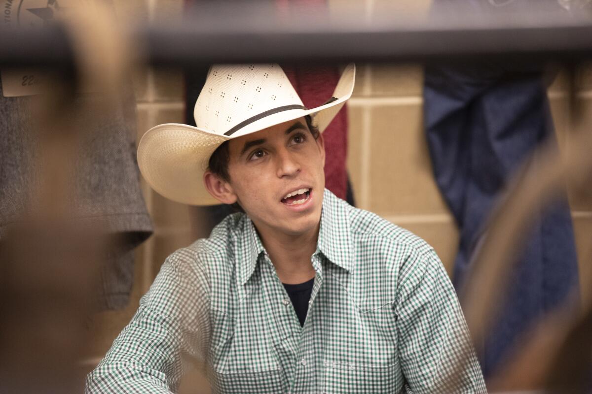 A man in a cowboy hat and checked shirt