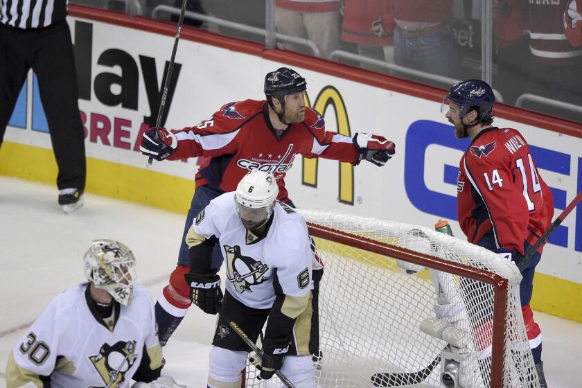 Capitals right wing Justin Williams (14) celebrates his goal with teammate Jason Chimera during the second period of Game 5 against the Penguins on Saturday.