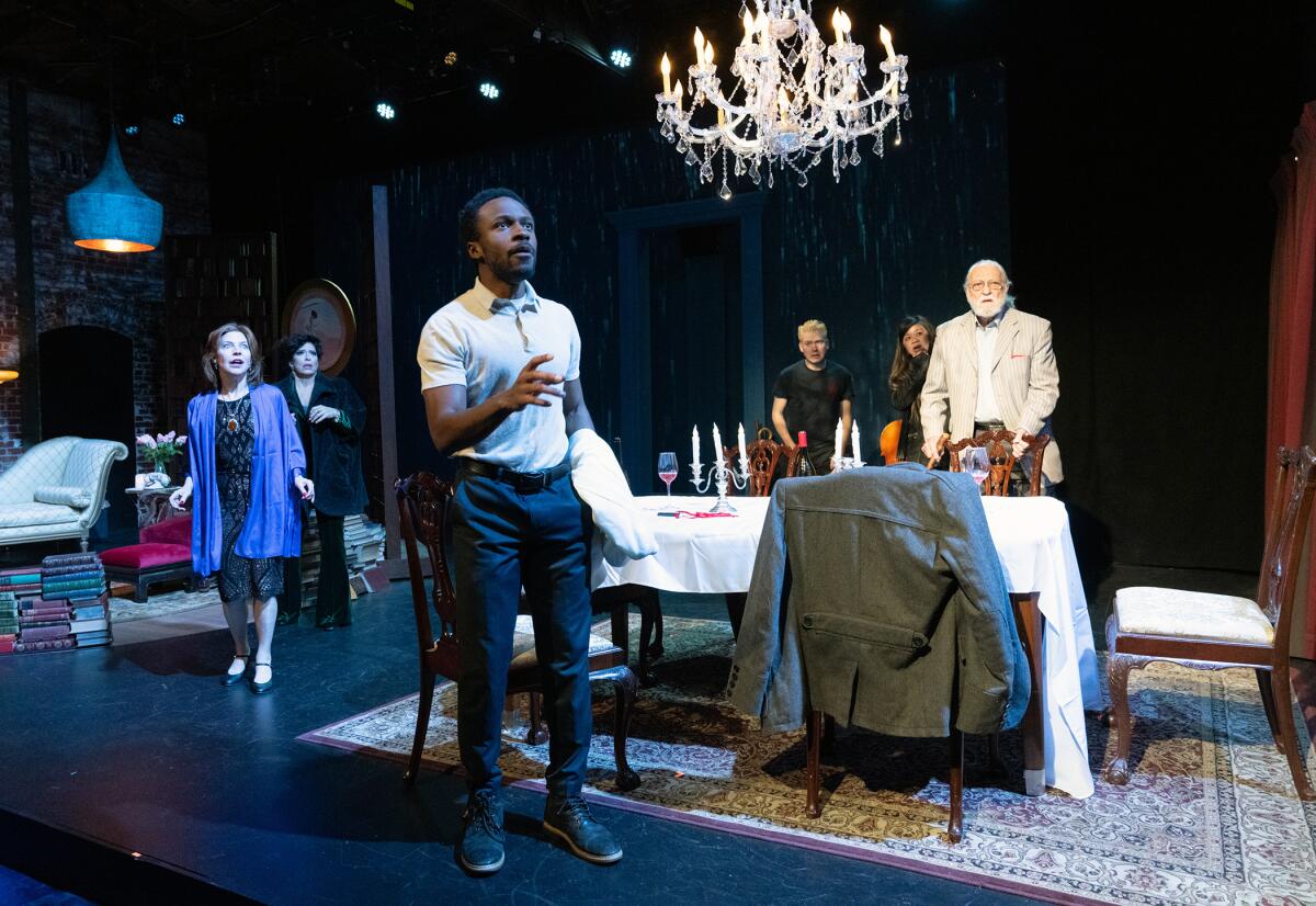 people on stage in a dining room scene